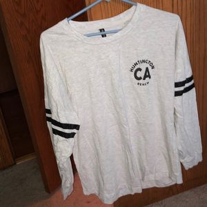 cream and black long sleeve Huntington Beach shirt